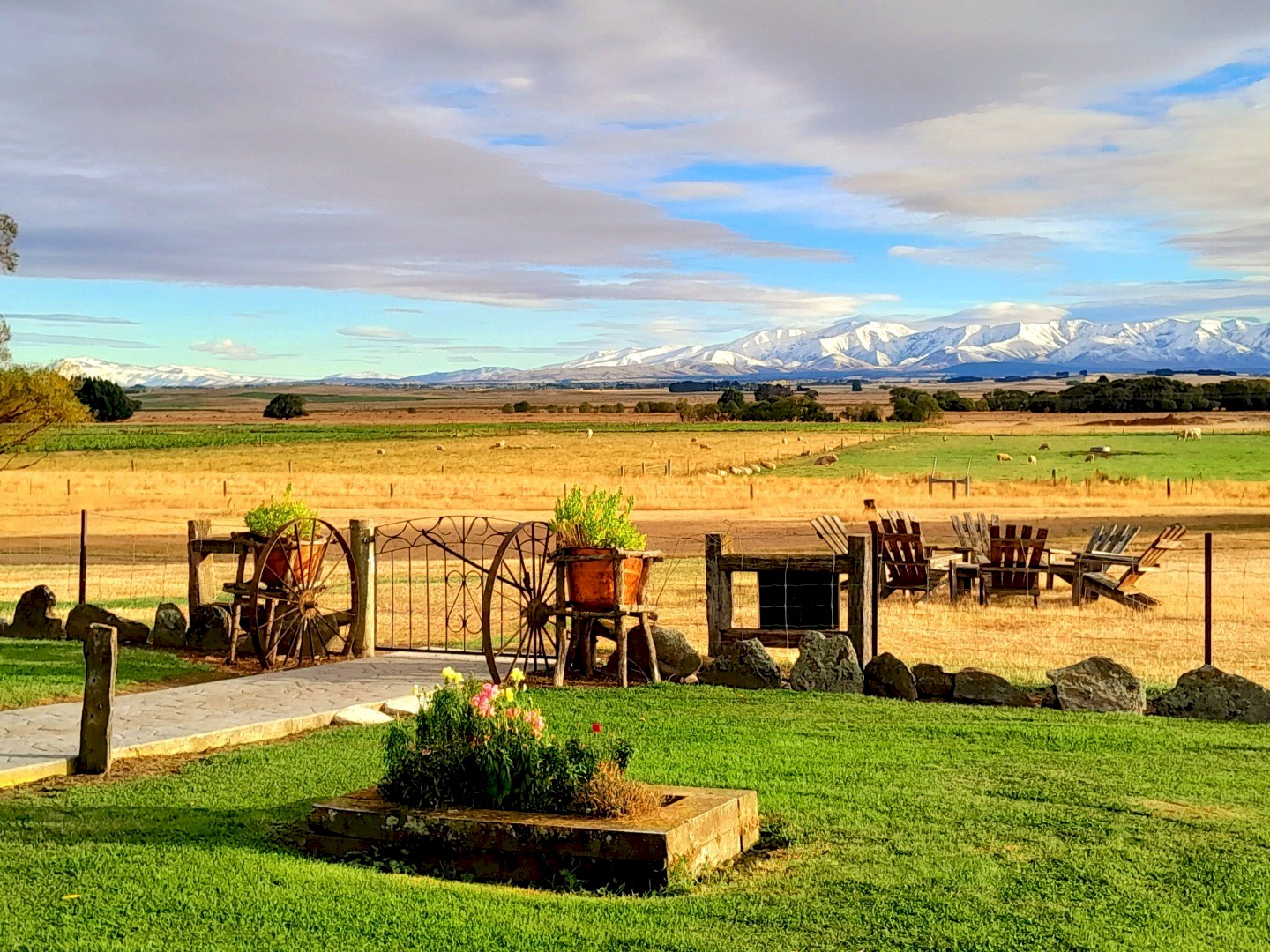 Peter's Farm Lodge garden and grounds looking out to the snow-capped Maniototo mountains